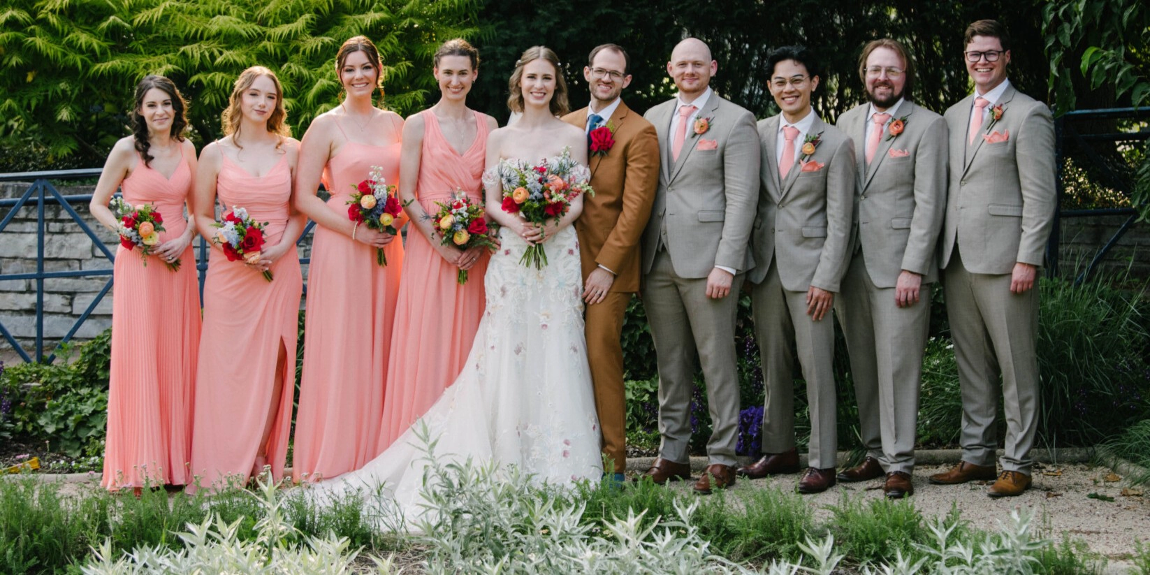 A group photo of the wedding party with members arranged from left to right in the order of: 